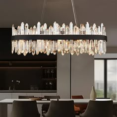 a modern chandelier hanging over a dining room table