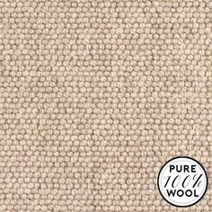 a close up shot of the texture of a beige wool carpet with a white circle on it