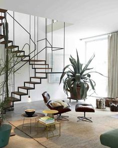 a living room filled with furniture and a stair case