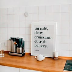 a kitchen counter with a sign on it that says un cafe deux croissants et troiss baisers