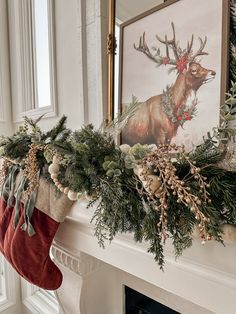 christmas stockings hanging from the mantle with deer and pine cones on it's stocking