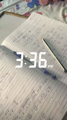 an alarm clock sitting on top of a notebook