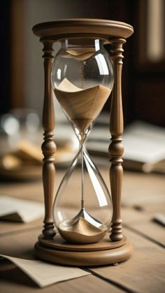 an hourglass sitting on top of a wooden table