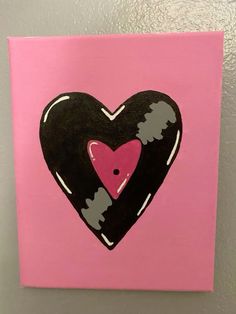 a pink and black heart painted on a wall