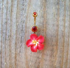 a red flower is attached to a gold cartilage