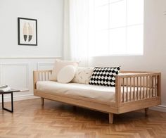 a living room with white walls and wood flooring