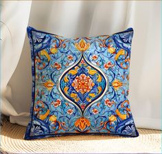 a blue and orange pillow sitting on top of a bed