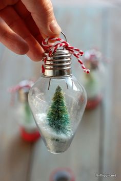 someone is holding an ornament with a christmas tree in it and the words best 25 + christmas ornaments ideas on pinterest