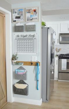 a refrigerator with magnets and pictures on the wall next to it in a kitchen