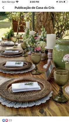 the table is set with plates and vases