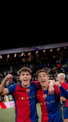 two soccer players are celebrating with their arms around each other