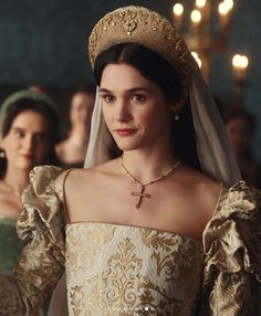 the tudors are dressed in period clothing and tiaras for their wedding ceremony,