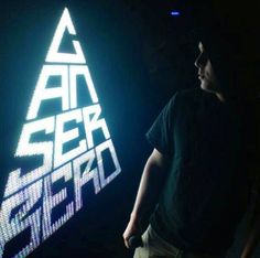 a man standing in front of a sign that says air seier zero on it