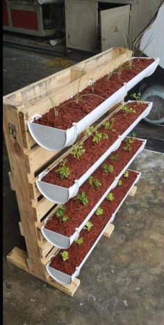 three tiered wooden planter with plants growing in it