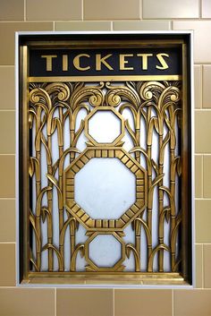 an art deco window in the shape of a ticket booth