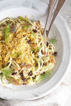 a white bowl filled with pasta and vegetables