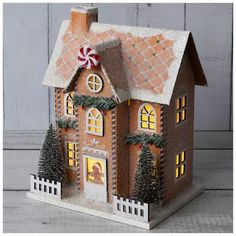 a gingerbread house is decorated with christmas decorations