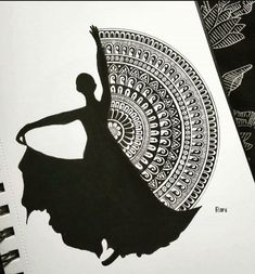 a black and white drawing of a ballerina in front of a circular design on a notebook