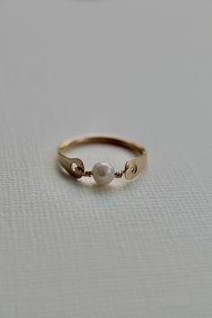 Add a little bit of elegance to your look with this Freshwater Pearl ring. Feel free to choose your own color for packaging and leave me a note before checkout under "Order special instructions", or I'll choose at random (for example, I have light blue, dark green, cream, and rust, out of 129 colors). Sold individually Approximately 4mm wide at the widest hammered point A genuine, ethically sourced semi-round Freshwater Pearl in the center (4-4.5mm wide) 2 grams in weight Please expect slight im Freshwater Pearl Ring, Hammered Ring, Hammered Rings, Thread Colors, Green Cream, Blue Dark, Pearl Ring, Embroidery Thread, Fresh Water