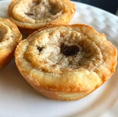 three small pastries on a white plate