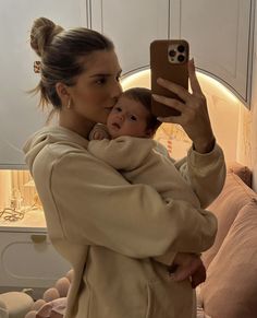 a woman taking a selfie with her baby