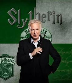 a man standing in front of a green and white wall with slytherin on it