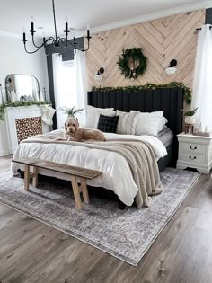 a dog laying on top of a bed in a bedroom