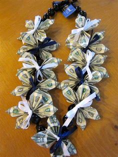 a necklace made out of dollar bills on a table