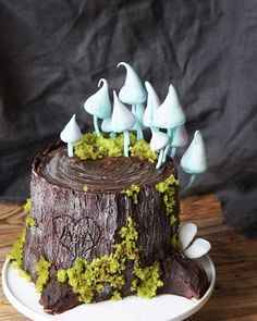 a chocolate cake with green frosting and small white birds sitting on top of it