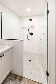 a bathroom with a walk in shower next to a sink