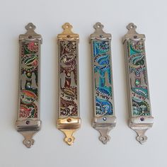 three different types of decorative handles on a white surface, one with an ornate design and the other without