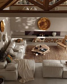 an overhead view of a living room with couches, tables and rugs on the floor