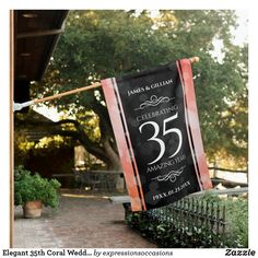 a 50th birthday banner hanging from a clothes line on a brick walkway with trees in the background