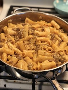 a pan filled with pasta on top of a stove