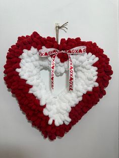 a crocheted heart hanging on the wall