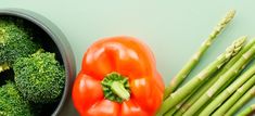 broccoli, tomatoes and asparagus are on the table next to each other