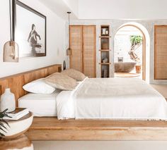 a bed sitting in a bedroom next to a doorway