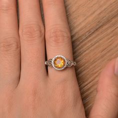 It is a natural citrine ring. The main stone is 7mm*7mm round cut, weight about 1.25 carats. To change the metal to a solid gold (white/rose) or platinum is also available, please ask for a quotation if you want. You can also go to my shop Home for more elegant rings: https://www.etsy.com/shop/godjewelry?ref=hdr_shop_menu citrine is November birthstone Customization is always welcome and please feel free to contact with me if you have any design ideas! Citrine Rings With Accent Stones, Topaz Ring With Yellow Sapphire And Accent Stones, Round Topaz Ring With Yellow Sapphire And Accent Stones, Round Topaz Ring With Citrine Center Stone, Yellow Ring With Halo Setting, Topaz Citrine Ring With Center Stone, Yellow Sapphire Topaz Ring With Accent Stones, Citrine Birthstone Ring With Accent Stones, Orange Round Yellow Sapphire Jewelry