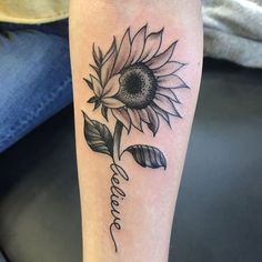 a woman's arm with a sunflower and the word love tattooed on it