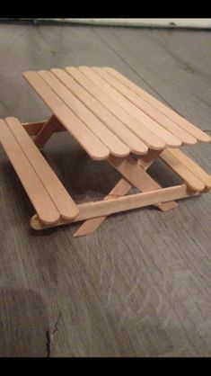 a small wooden bench sitting on top of a hard wood floor