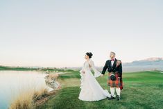 a bride and groom holding hands on the golf course