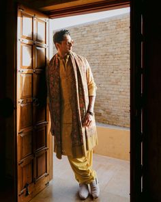 a man is standing in an open doorway