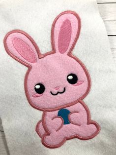 a white towel with a pink bunny on it