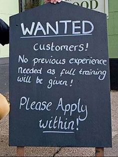 a man is holding a sign that says, wanted customers no previous experience needed as full training will be given please apply within