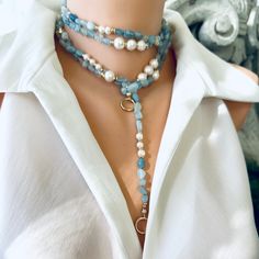 Introducing a stunning masterpiece of jewelry, the Hand Knotted Baroque Aquamarine & Fresh Water Pearls Necklace. This exquisite necklace features a mesmerizing combination of natural shaded aquamarine beads and lustrous freshwater pearls, meticulously hand-knotted to create a breathtakingly beautiful design. With a remarkable length of 65 inches, this unique necklace offers endless layering possibilities, allowing you to effortlessly elevate your style and create stunning statement looks. The g Blue Gemstone Lariat Necklace, Blue Lariat Necklace With Natural Stones, Blue Distinctive Necklaces For Party, Blue Necklace With Unique Variations For Party, Elegant Blue Lariat Necklace Gift, Elegant Single Strand Blue Jewelry, Blue Necklaces With Unique Variations For Parties, Elegant Blue Single Strand Jewelry, Handmade Blue Lariat Long Necklace