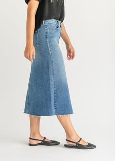 Let us introduce you to the denim skirt you'll want to wear with everything, the Lee A-Line Raw Hem Midi Skirt! This stunning midi denim skirt is an Inherit Design made in the USA! Crafted from high quality, stretchy, medium wash denim that is super soft and will keep you comfortable all day long. The A-line fit is walkable, modest, and on-trend with a raw hem. This sustainable, modest, American-crafted skirt is a true seasonless staple you will wear for years to come! Style | Midi, Denim Color Midi Denim Skirt, Midi Denim, Professional Wardrobe, Church Dresses, Denim Color, Back To School Shopping, Denim Midi Skirt, Colored Denim, Natural Fabrics