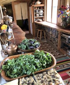 some food is laying out on a table in the kitchen and there are many other foods to eat