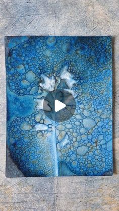 a piece of art that looks like it has been made with blue and white paint