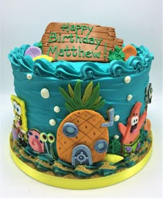 a birthday cake decorated with an image of a pineapple and other tropical animals on it