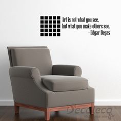 a chair sitting in front of a wall with a quote on it